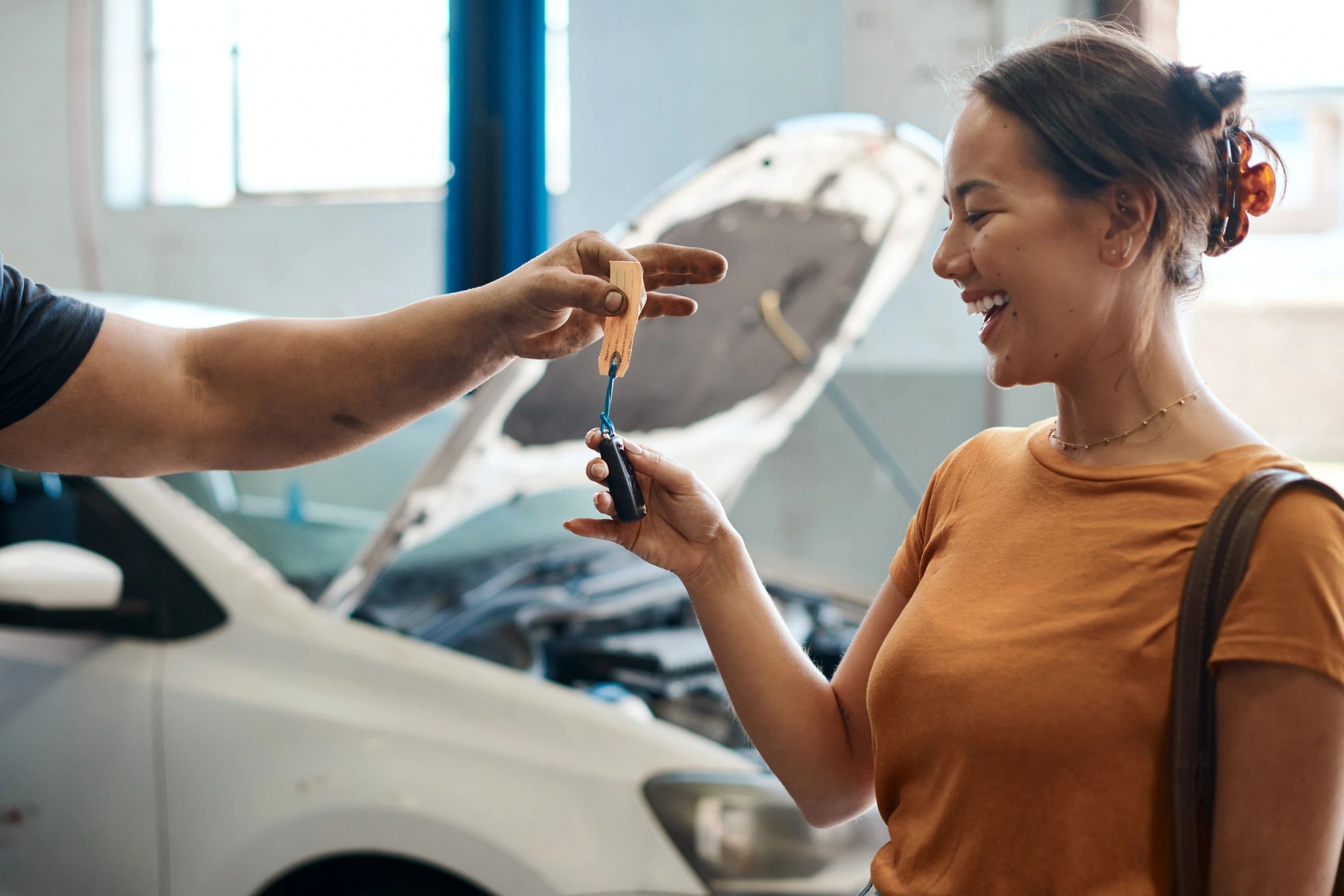 Customer receiving car keys at a service counter