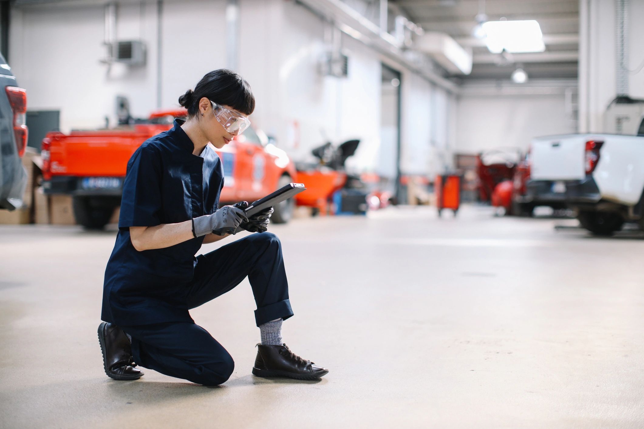 Technician using a tablet for vehicle inspection and diagnostics