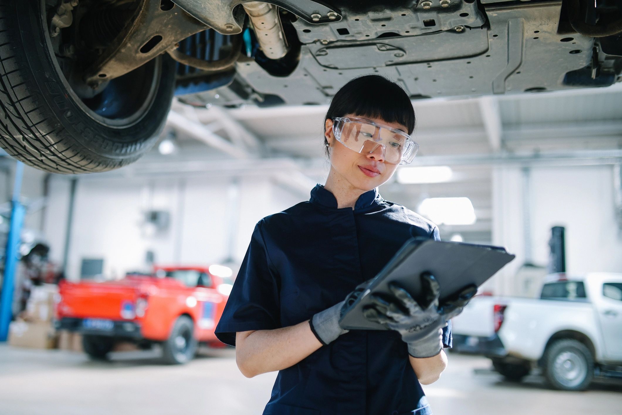 ASE-certified mechanic inspecting a vehicle in a professional auto shop