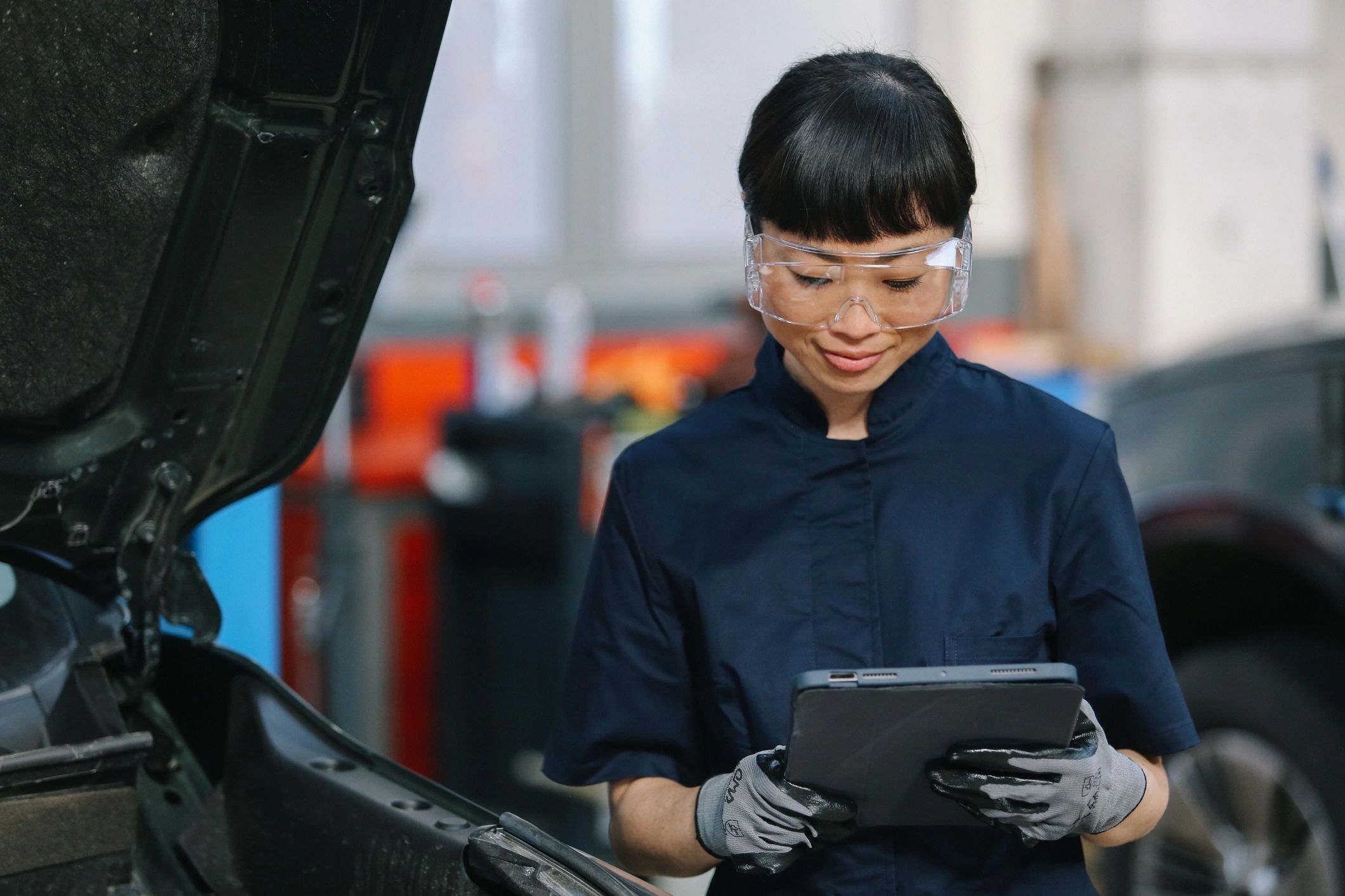 Technician inspecting a vehicle during routine maintenance
