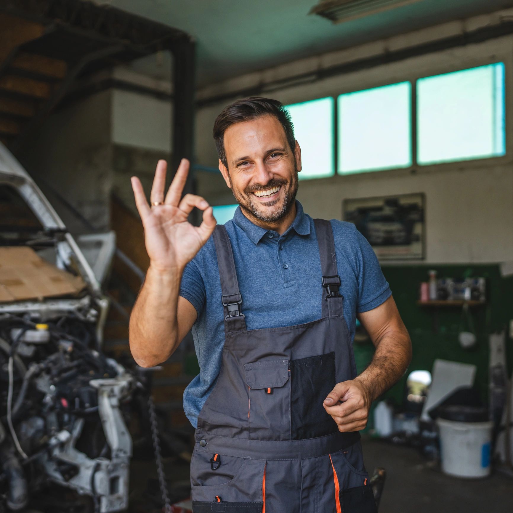 Service advisor smiling in an auto workshop